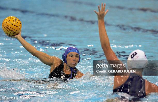 Kelly Rulon of the US tries to defend as an unidentified Canadian player looks for the open shot during their women's waterpolo preliminary Group B...