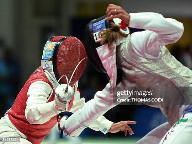 Venezuela's Mariana Gonzalez competes against Italy's Valentina Vezzali during the Women's individual foil fencing qualifying, at the Helliniko...