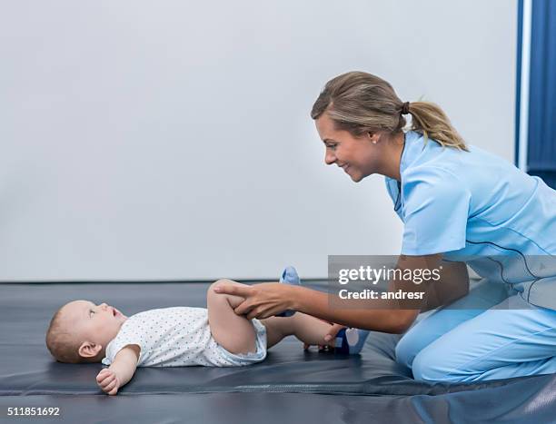 baby in physical therapy - orthopedic equipment stock pictures, royalty-free photos & images