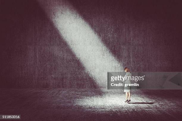 businesswoman standing under the spotlight - guilt stock pictures, royalty-free photos & images