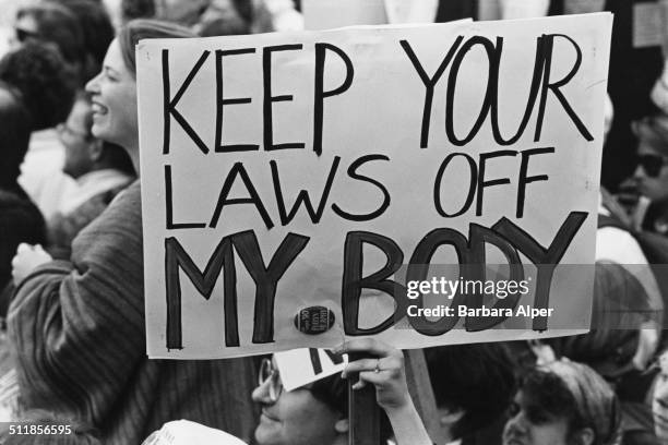 Pro-choice campaigners at a March for Women's Equality in Washington, DC, 9th April 1989. One placard reads 'Keep your laws off my body'.