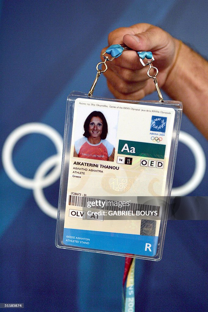 An Olympic Games volunteer holds up the