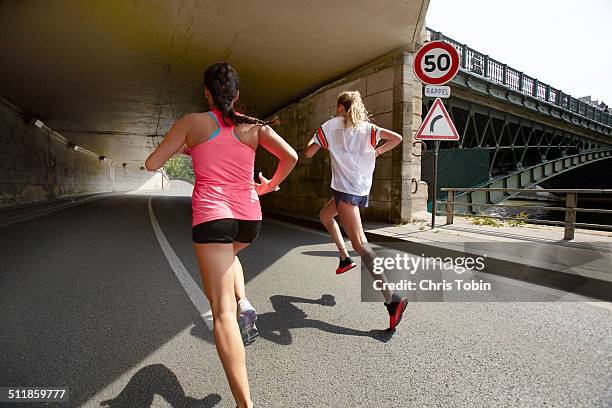 women running through tunnel - paris sport stock pictures, royalty-free photos & images