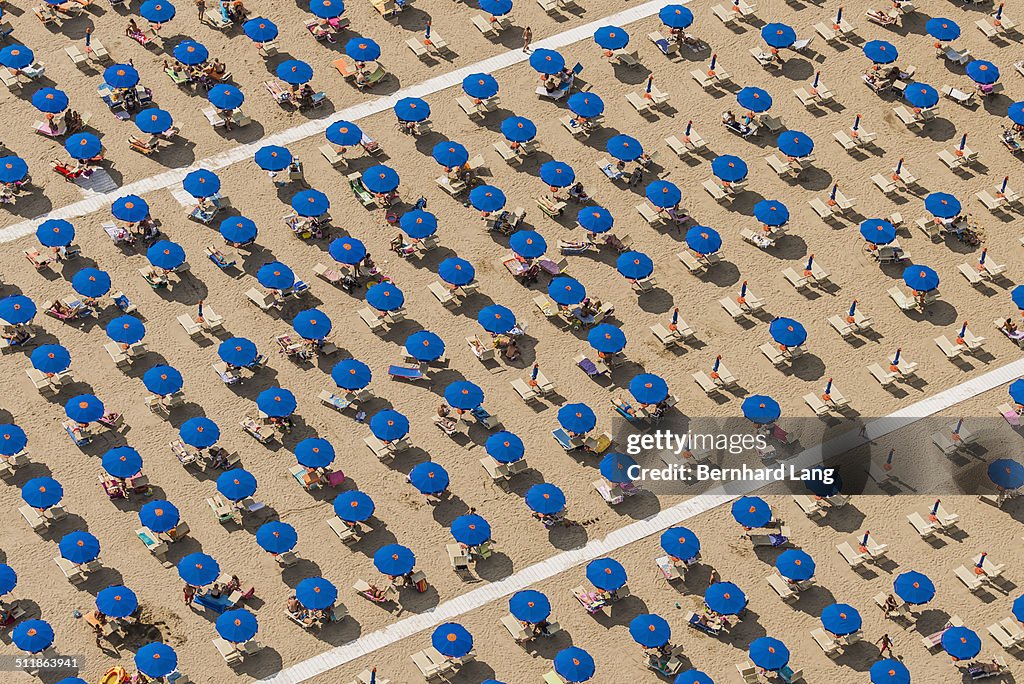 Aerial View of blue sunshades standing in rows