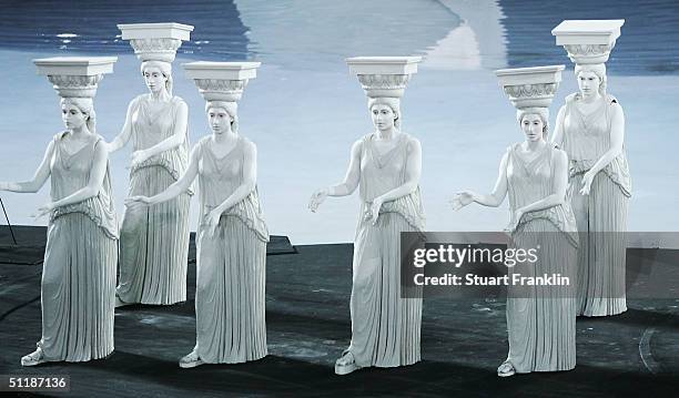Performers dressed as ancient greek statues acts out a scene representing a period of Greek culture and art during the opening ceremony of the Athens...