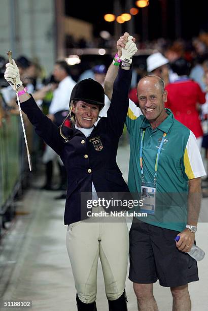 Bettina Hoy of Germany celebrates with her husband, equestrian Andrew Hoy of Australia after Bettina won the gold medal in the individual three day...