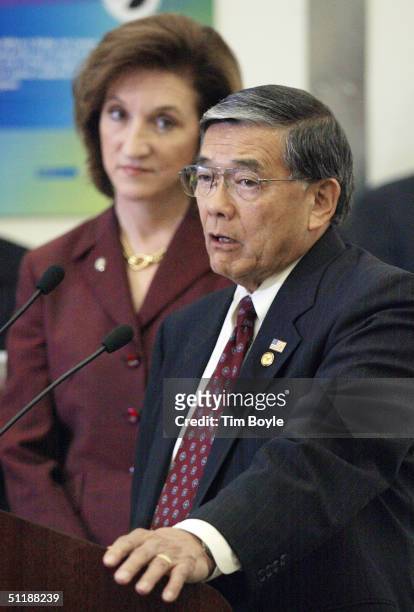 Marion C. Blakey, Administrator, Federal Aviation Administration, left, looks on as U.S. Secretary of Transportation Norman Y. Mineta speaks to the...