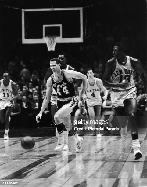 American basketball player Jerry West, Los Angeles Lakers, dribbles the ball down the court against the New York Knicks, 1960s.