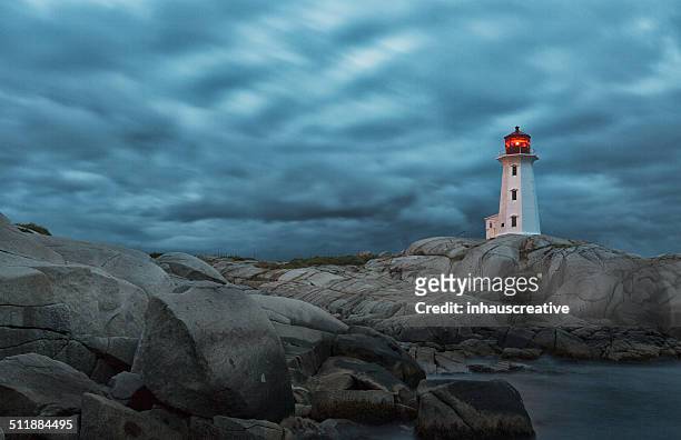 lighthouse on a stormy night - storm lighthouse stockfoto's en -beelden