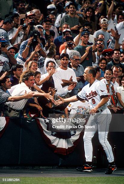 Cal Ripken Jr of the Baltimore Orioles acknowledge the fans as he gets a standing ovation for playing in his 2131st consecutive Major League baseball...