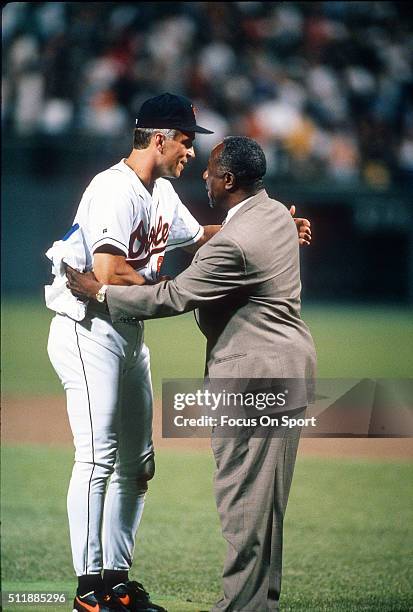 Baseball Great Hank Aaron congratulates Cal Ripken Jr of the Baltimore Orioles for playing in his 2131st consecutive Major League baseball game...