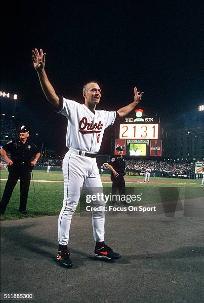 Cal Ripken Jr of the Baltimore Orioles acknowledge the fans as he gets a standing ovation for playing in his 2131st consecutive Major League baseball...