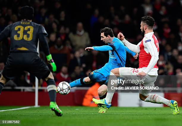 Arsenal's Czech goalkeeper Petr Cech watches Arsenal's French striker Olivier Giroud block a shot from Barcelona's Argentinian forward Lionel Messi...