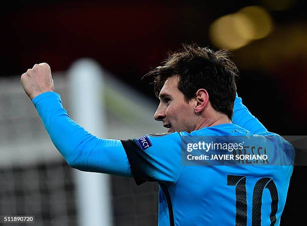 Barcelona's Argentinian forward Lionel Messi celebrates scoring his team's first goal during the UEFA Champions League round of 16 1st leg football...