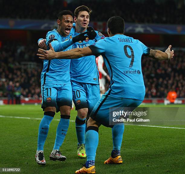 Lionel Messi of Barcelona celebrates with team mates after scoring the first goal during the UEFA Champions League round of 16 first leg match...