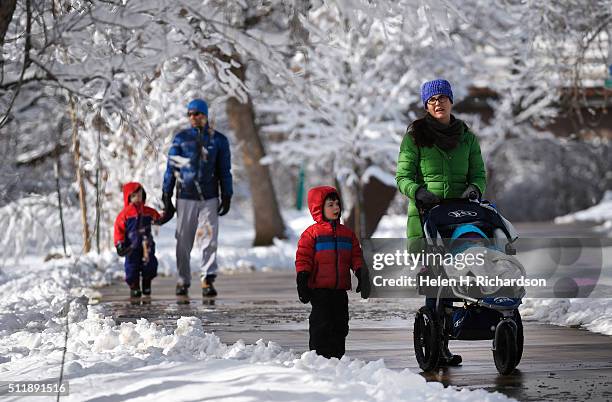 Allison Schwartz and her family enjoy a walk along Boulder Creek amidst trees covered with snow on February 23, 2016 in Boulder, Colorado. With...