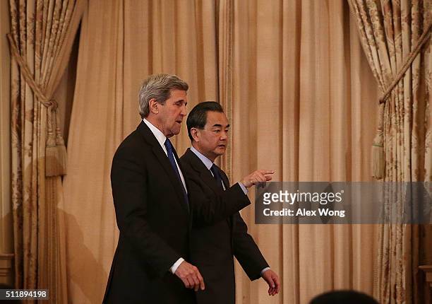 Secretary of State John Kerry and Chinese Foreign Minister Wang Yi approah the podiums for a joined news conference at the State Department February...