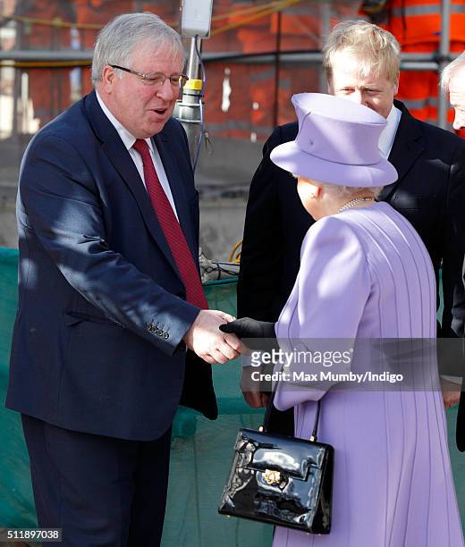 Transport Secretary Patrick McLoughlin greets Queen Elizabeth II as she arrives for a visit to the Crossrail station site at Bond Street on February...