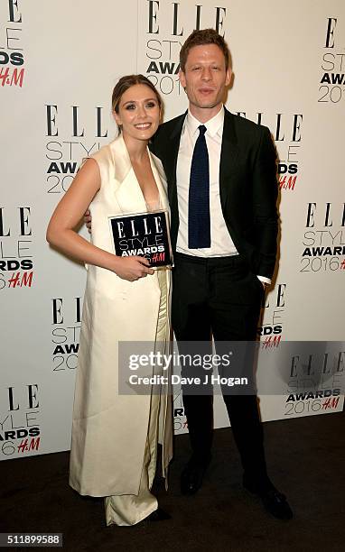 Elizabeth Olsen, winner of the actress of the year award, poses with presenter James Norton poses in the winners room at The Elle Style Awards 2016...