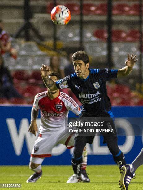 Juan Forlin of Queretaro vies for the ball with Luciano Acosta of DC United, during their CONCACAF Quarterfinal Champions League football match at...