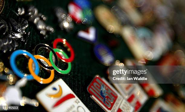 Olympic pins are pictured on sale by a vendor near the Main Stadium August 19, 2004 in Athens, Greece.