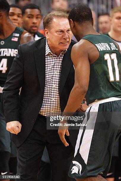 Head Coach Tom Izzo of the Michigan State Spartans gives instructions to Lourawls Nairn Jr. #11 of the Michigan State Spartans during a break in the...