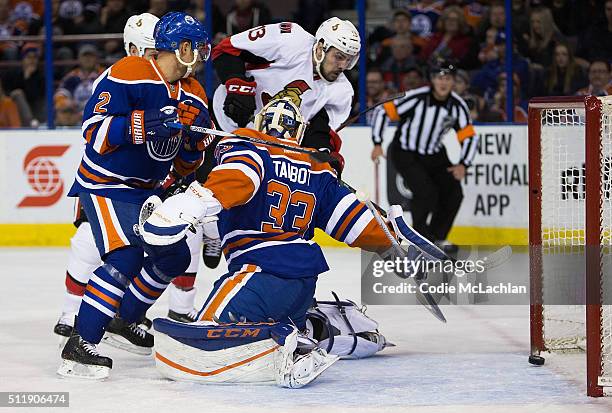Andrej Sekera and goaltender Cam Talbot of the Edmonton Oilers can't stop Nick Paul of the Ottawa Senators from scoring a goal on February 23, 2016...
