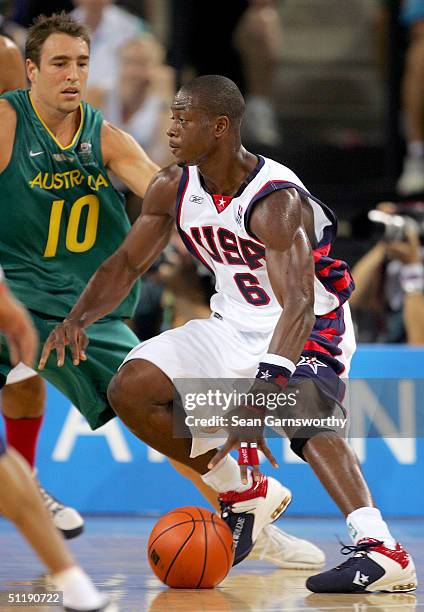 Dwyane Wade of the USA dribble drives to the basket against Jason Smith of Australia during the men's basketball preliminary game on August 19, 2004...