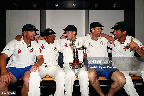 David Warner, Usman Khawaja, Steve Smith, Adam Voges and Joe Burns of Australia celebrate with the Trans-Tasman Trophy in the change rooms after day...