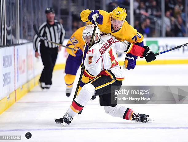 Tanner Pearson of the Los Angeles Kings is checked by Mark Giordano of the Calgary Flames during the second period at Staples Center on February 23,...