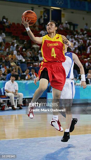Xiaoyun Song of China goes up for a layup against Korea in the women's basketball preliminary game on August 14, 2004 during the Athens 2004 Summer...