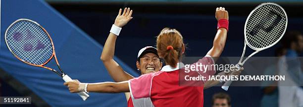 Japan's Shinobu Asagoe and Ai Sugiyama celebrate their 6-4, 4-6, 6-4 victory over Lisa Raymond and Martina Navratilova of the USA during the...
