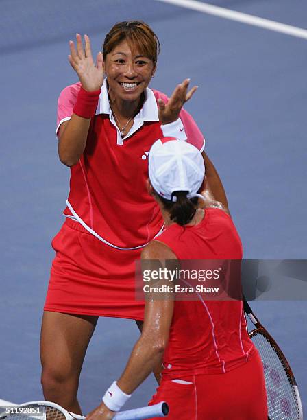 Shinobu Asagoe and Ai Sugiyama of Japan celebrate during the women's doubles tennis quarterfinal match against Martina Navratilova and Lisa Raymond...