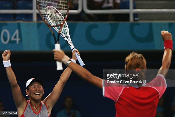 Ai Sugiyama and Shinobu Asagoe of Japan celebrate winning the women's doubles tennis quarterfinal match against Martina Navratilova and Lisa Raymond...