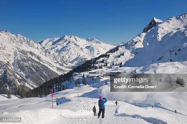 woman enjoying winter hiking - sonnenkopf stock pictures, royalty-free photos & images