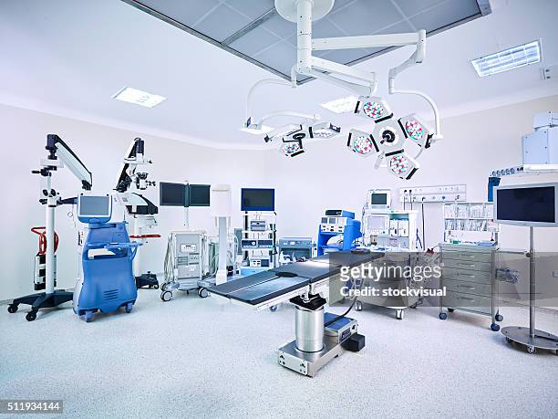 modern hospital operating room with monitors and equipment - operating room stockfoto's en -beelden