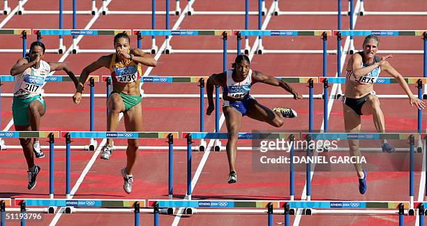 India's J.J. Shobha, Portugal's Naide Gomes, Britain's Denise Lewis, and Germany's Karin Ertle, compete in heat three of the women's heptathlon 100m...