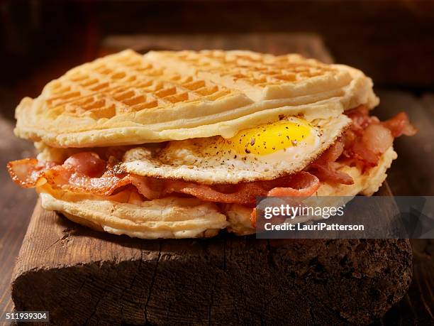 fried egg and bacon waffle sandwich - waffle stock pictures, royalty-free photos & images