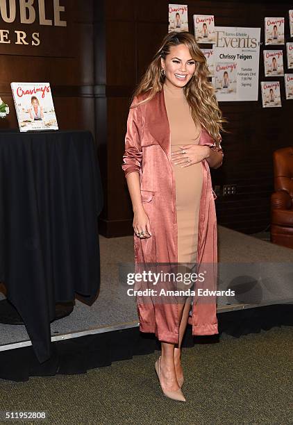 Model Chrissy Teigen poses before signing copies of her book "Cravings: Recipes For All The Food You Want To Eat" at Barnes & Noble at The Grove on...