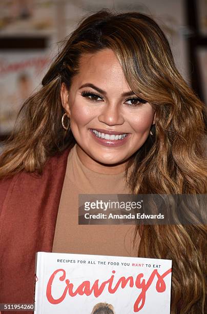 Model Chrissy Teigen poses before signing copies of her book "Cravings: Recipes For All The Food You Want To Eat" at Barnes & Noble at The Grove on...