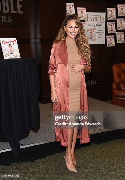 Model Chrissy Teigen poses before signing copies of her book "Cravings: Recipes For All The Food You Want To Eat" at Barnes & Noble at The Grove on...