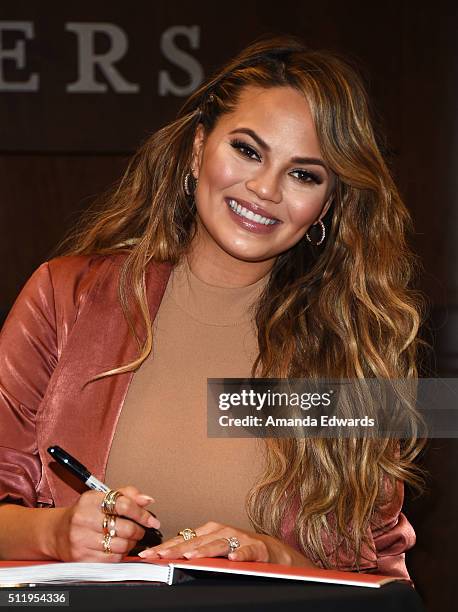 Model Chrissy Teigen signs copies of her book "Cravings: Recipes For All The Food You Want To Eat" at Barnes & Noble at The Grove on February 23,...