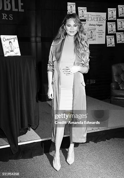 Model Chrissy Teigen poses before signing copies of her book "Cravings: Recipes For All The Food You Want To Eat" at Barnes & Noble at The Grove on...