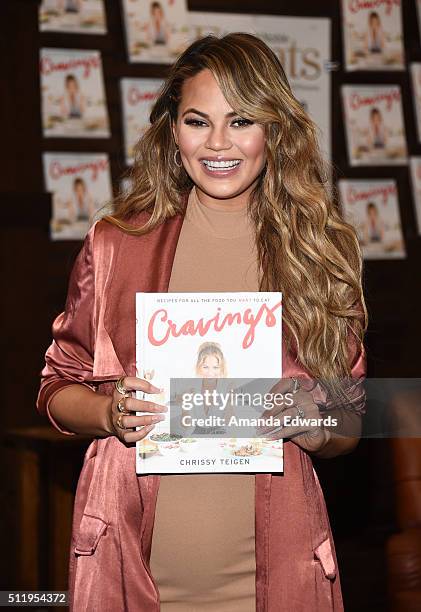 Model Chrissy Teigen poses before signing copies of her book "Cravings: Recipes For All The Food You Want To Eat" at Barnes & Noble at The Grove on...