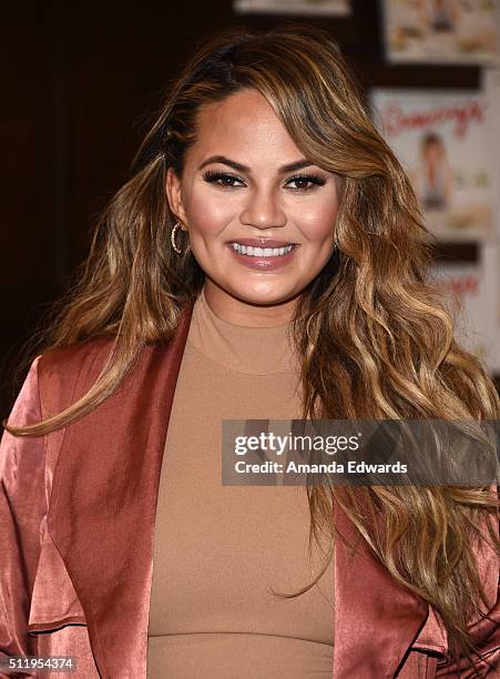 Model Chrissy Teigen poses before signing copies of her book "Cravings: Recipes For All The Food You Want To Eat" at Barnes & Noble at The Grove on...