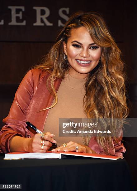 Model Chrissy Teigen signs copies of her book "Cravings: Recipes For All The Food You Want To Eat" at Barnes & Noble at The Grove on February 23,...