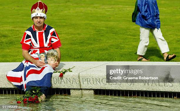 John Loughrey sits round the Princess Diana Memorial Fountain as it re-opens to the public, August 20 2004, in London's Hyde Park. The controversial...