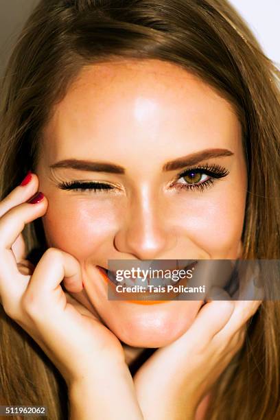 blonde woman smiling and waking - beauty shot - rossetto arancione foto e immagini stock
