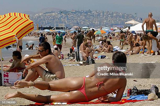 Tourists and locals are pictured enjoying the sun on a busy public beach in Athens, whilst Olympic venues suffer from poor attendances, August 20,...