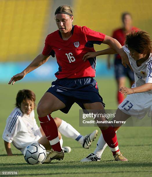 Abby Wambach of the United States dribbles the ball past Aya Shimokozuru of Japan competes in the women's football quarterfinal match on August 20,...